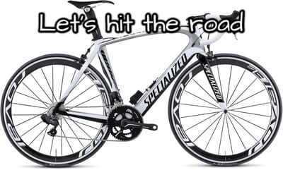 Bicycle with 'Let's hit the road' text overlay